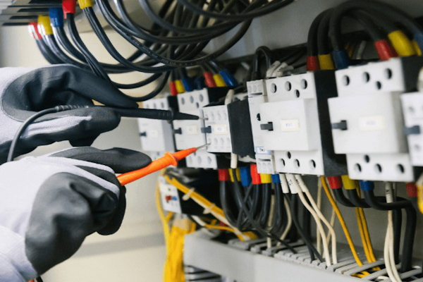 Electrician testing an electrical panel with professional equipment